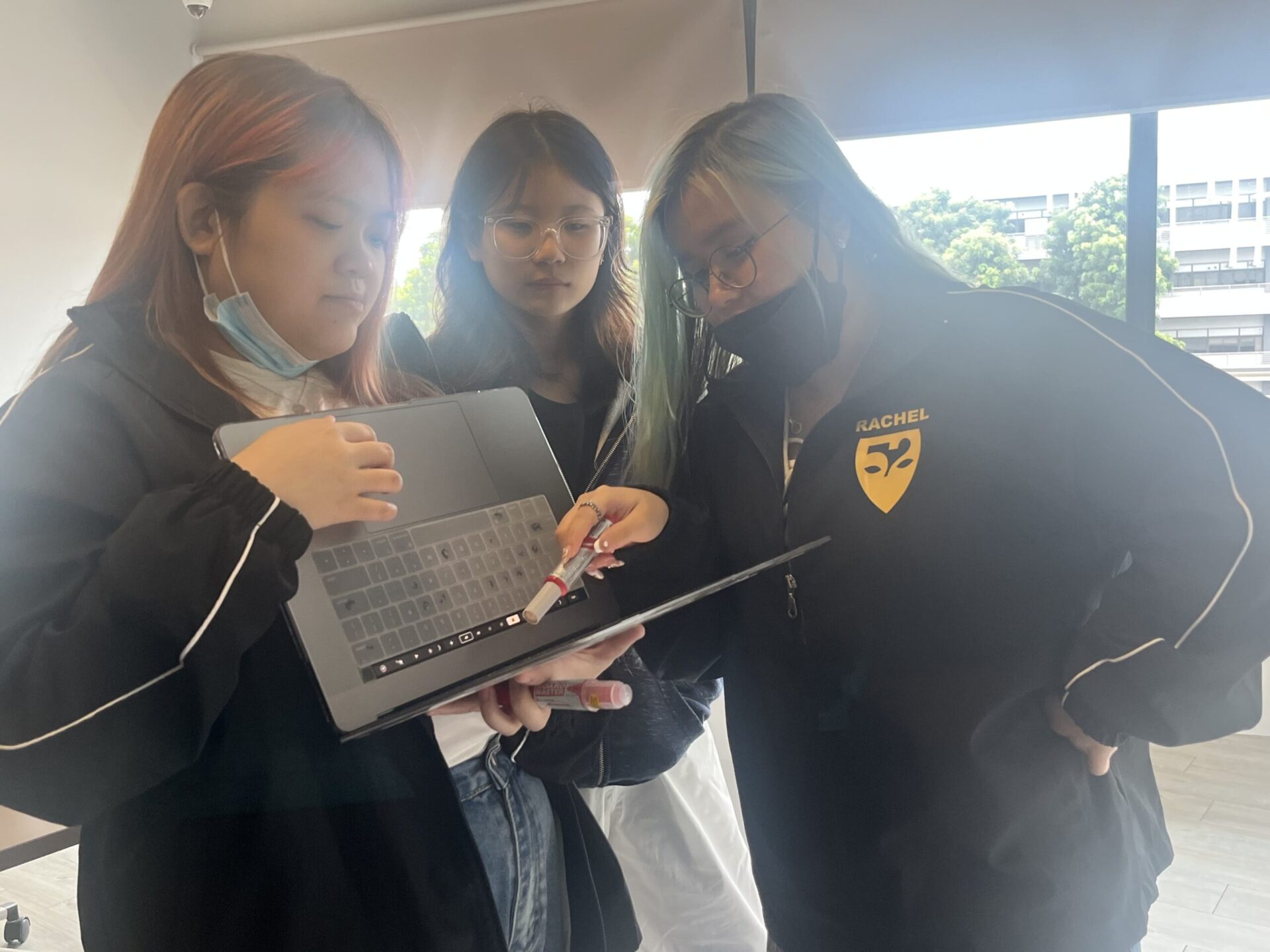 The team is discussing on a subject on one of the person's laptop